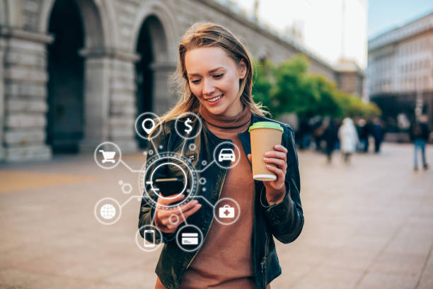 Beautiful young woman using a smartphone with various icons of smart technology.